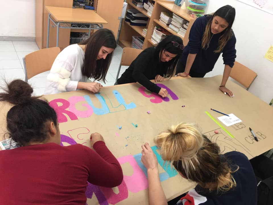 Un grupo d'de alumnas trabjando en una pancarta 